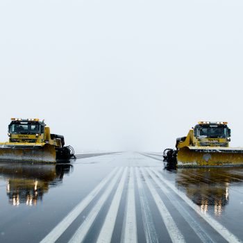 Tractors plowing ice and snow