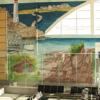 art mural on a wall showcasing a lighthouse and nature