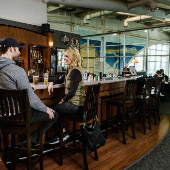 people chatting at a bar